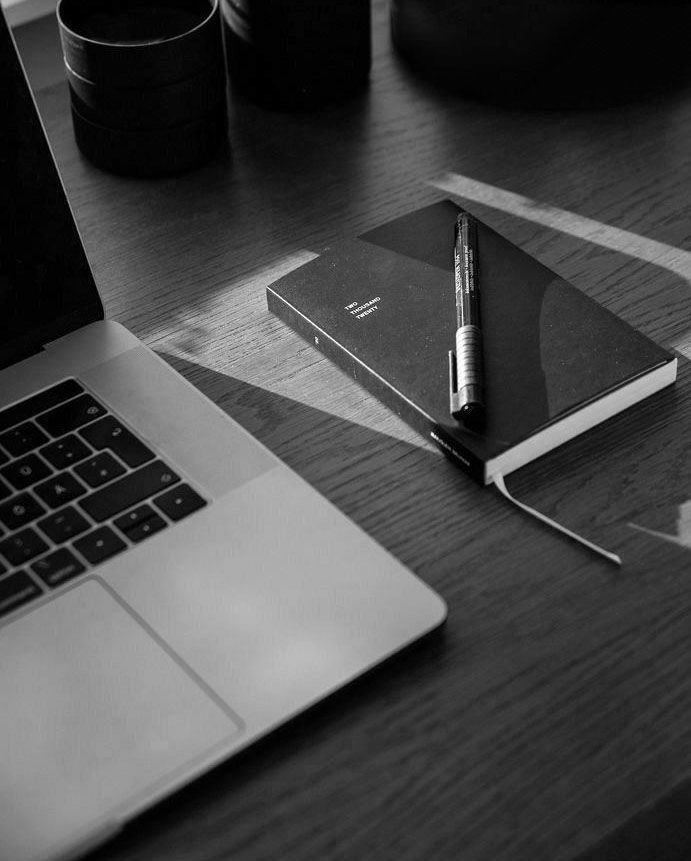 Laptop and notebook on a desk